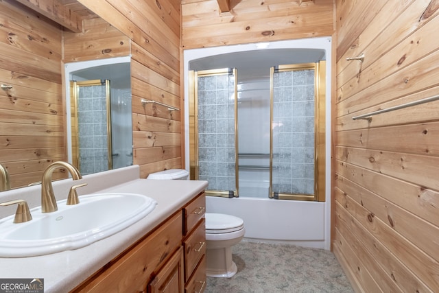 739 Barnes Mill Rd, Hamilton, GA 31811 - full bath featuring shower / bath combination with glass door, wooden walls, vanity, and toilet