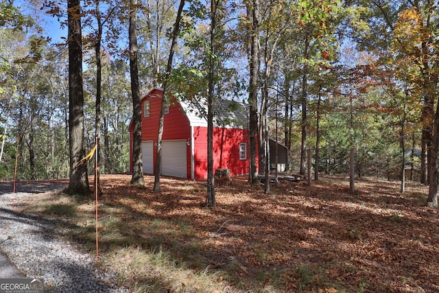 exterior space featuring a garage and an outbuilding