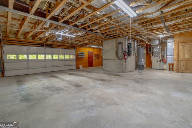 739 Barnes Mill Rd, Hamilton, GA 31811 - garage with water heater, a garage door opener, and heating unit