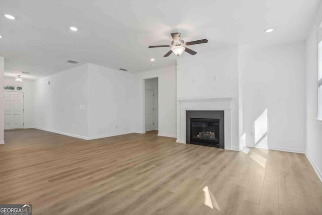 unfurnished living room featuring light wood-type flooring and ceiling fan