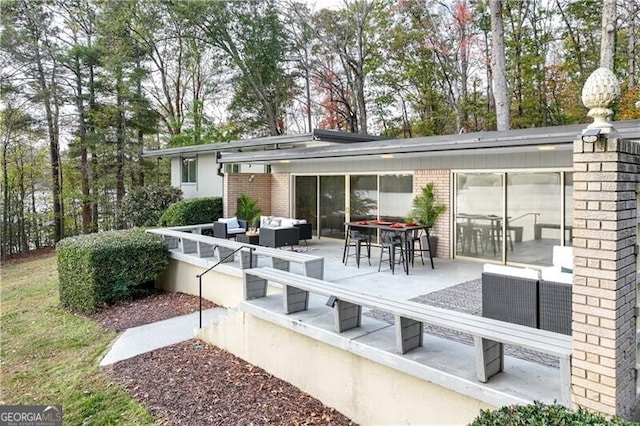 rear view of house with outdoor lounge area