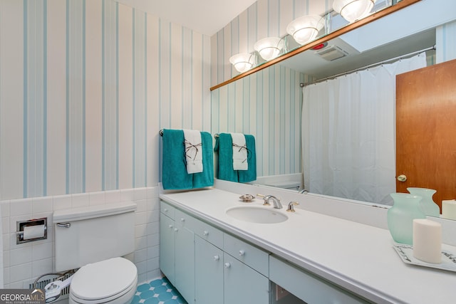 bathroom with vanity, tile patterned flooring, and toilet