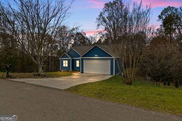 view of front of house featuring a garage and a yard