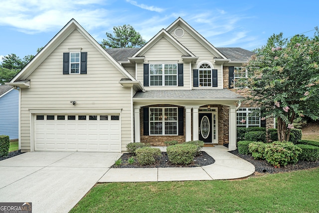 front of property featuring a front yard and a garage