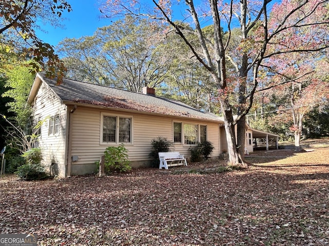 view of side of property featuring a carport