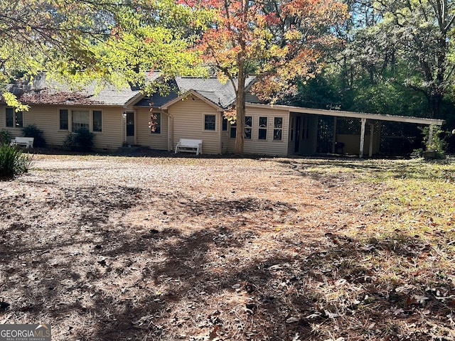 back of property with a carport