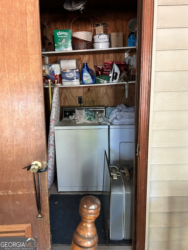 clothes washing area with separate washer and dryer