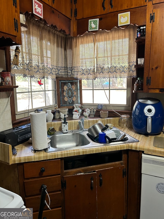 kitchen featuring decorative backsplash and a wealth of natural light