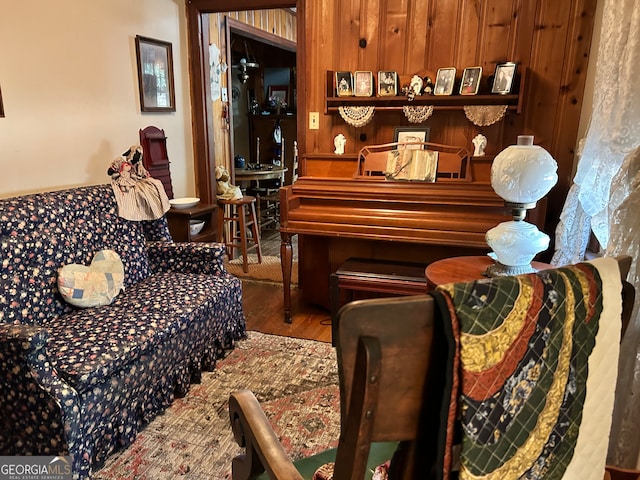 miscellaneous room with hardwood / wood-style floors and wood walls