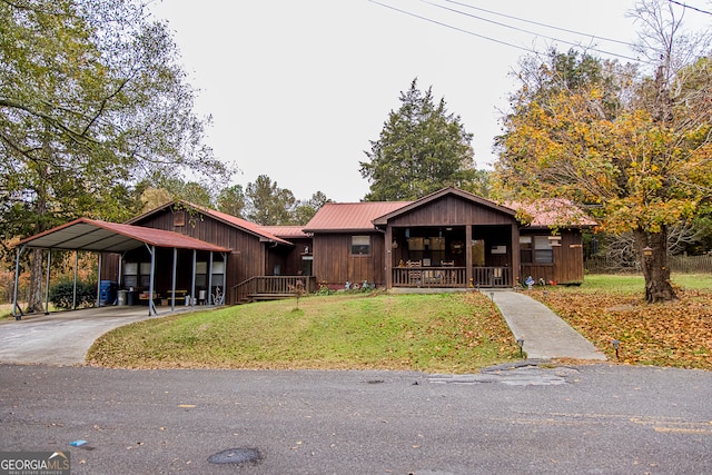 bungalow-style house with covered porch, a front lawn, and a carport