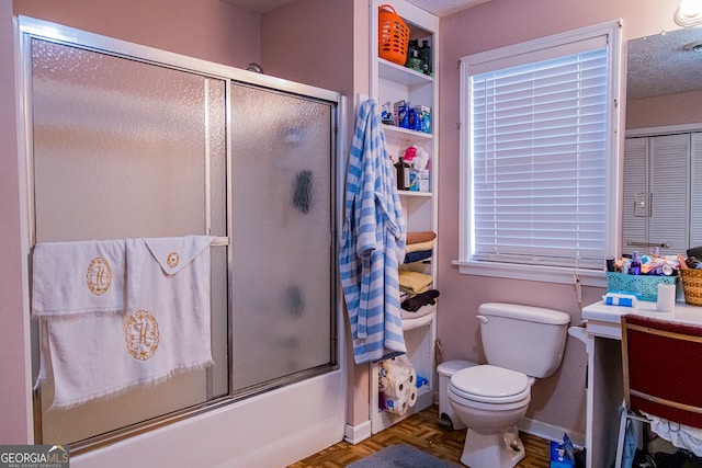 full bathroom with vanity, toilet, parquet floors, and bath / shower combo with glass door