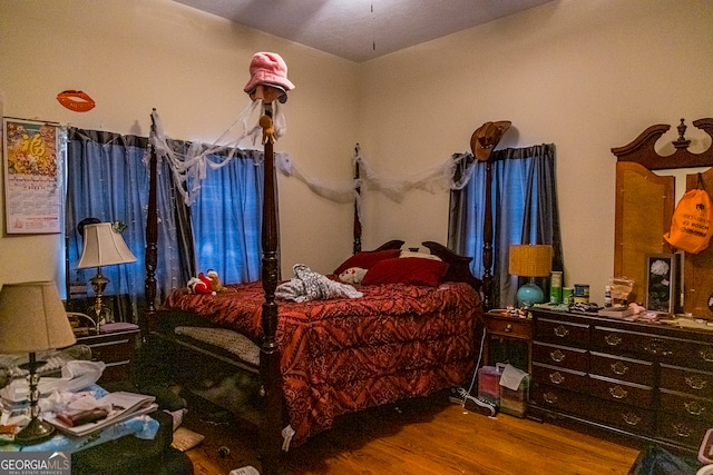 bedroom with hardwood / wood-style flooring