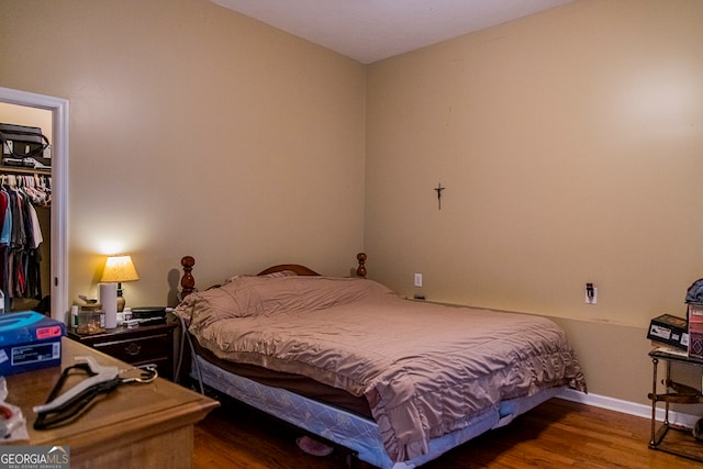 bedroom with hardwood / wood-style floors and a closet