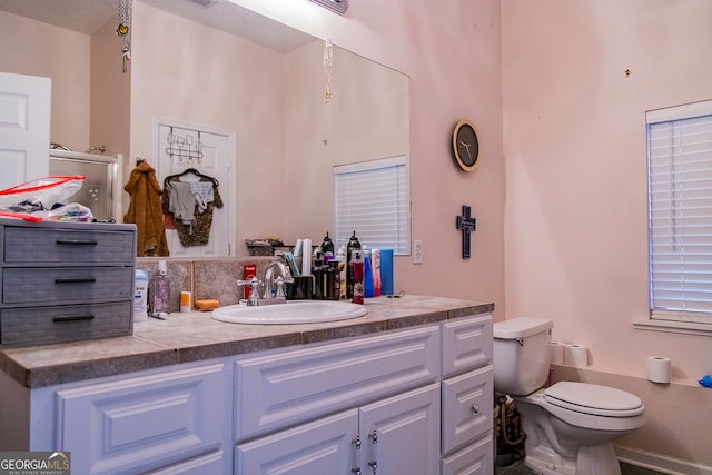 bathroom featuring vanity and toilet