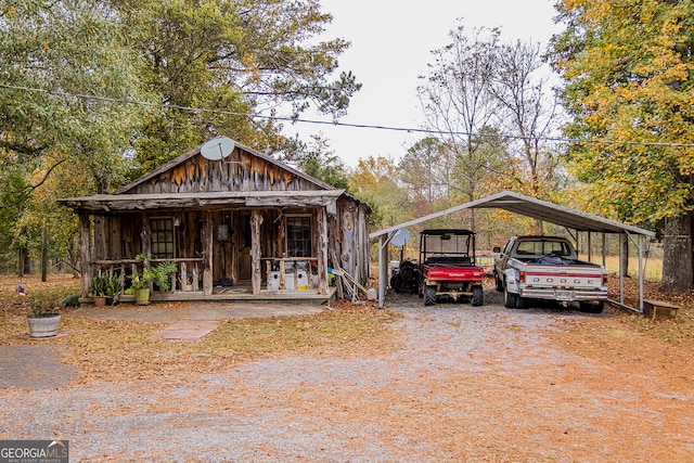 view of front of property with a porch and a carport