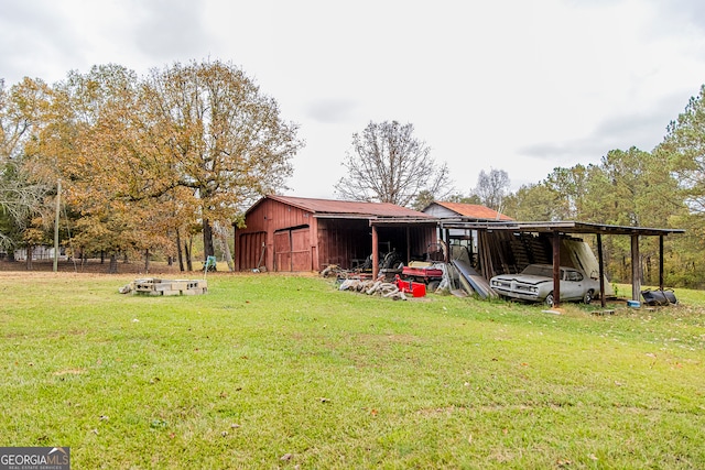 view of yard with a carport and an outbuilding