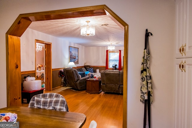 living room featuring light hardwood / wood-style floors and a chandelier