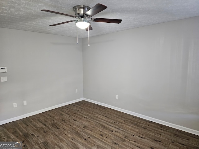 empty room featuring a textured ceiling, ceiling fan, and dark wood-type flooring