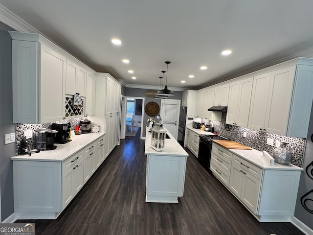 kitchen with white cabinets, crown molding, dark hardwood / wood-style floors, tasteful backsplash, and decorative light fixtures