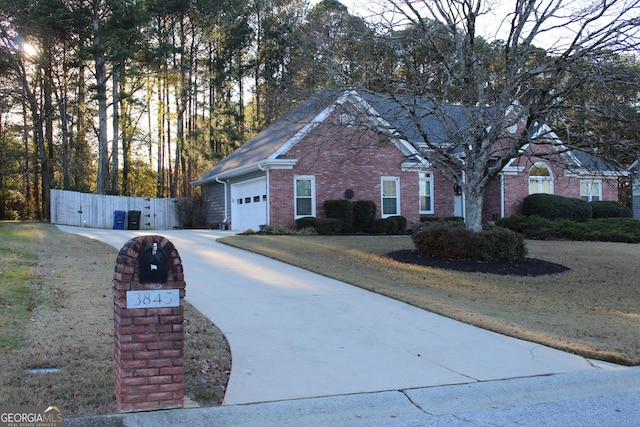 view of front of house with a front yard and a garage