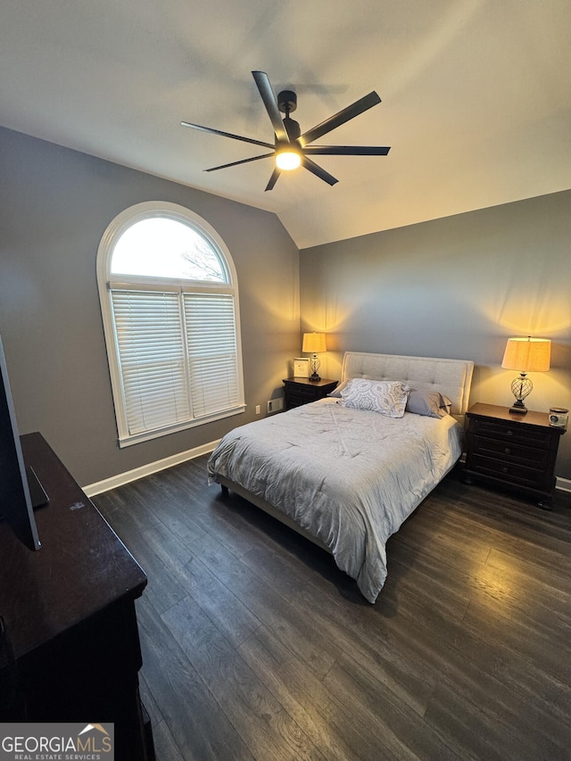 bedroom featuring ceiling fan, dark hardwood / wood-style flooring, and vaulted ceiling