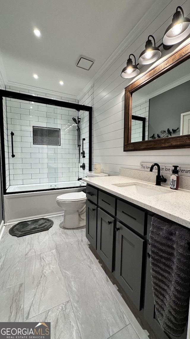 full bathroom featuring crown molding, toilet, vanity, and combined bath / shower with glass door