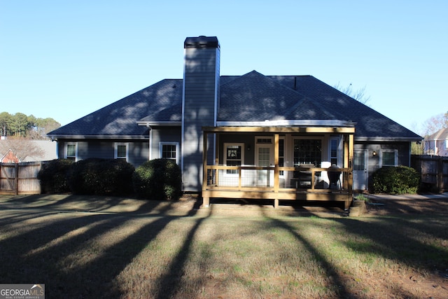 back of property featuring a yard