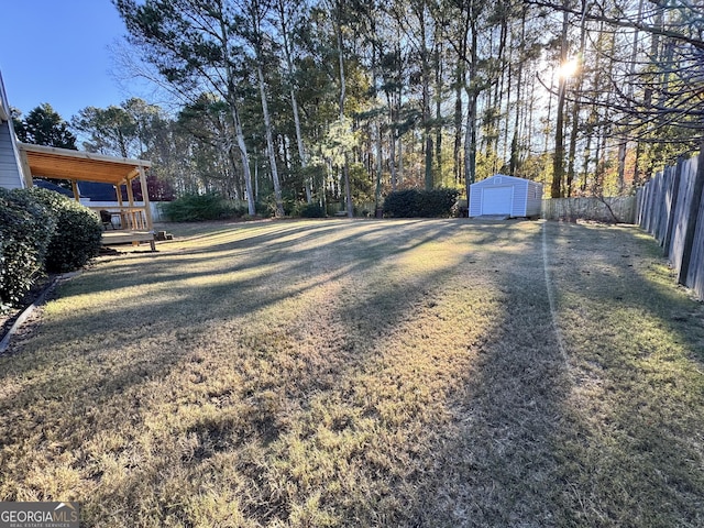 view of yard with a storage unit and a wooden deck