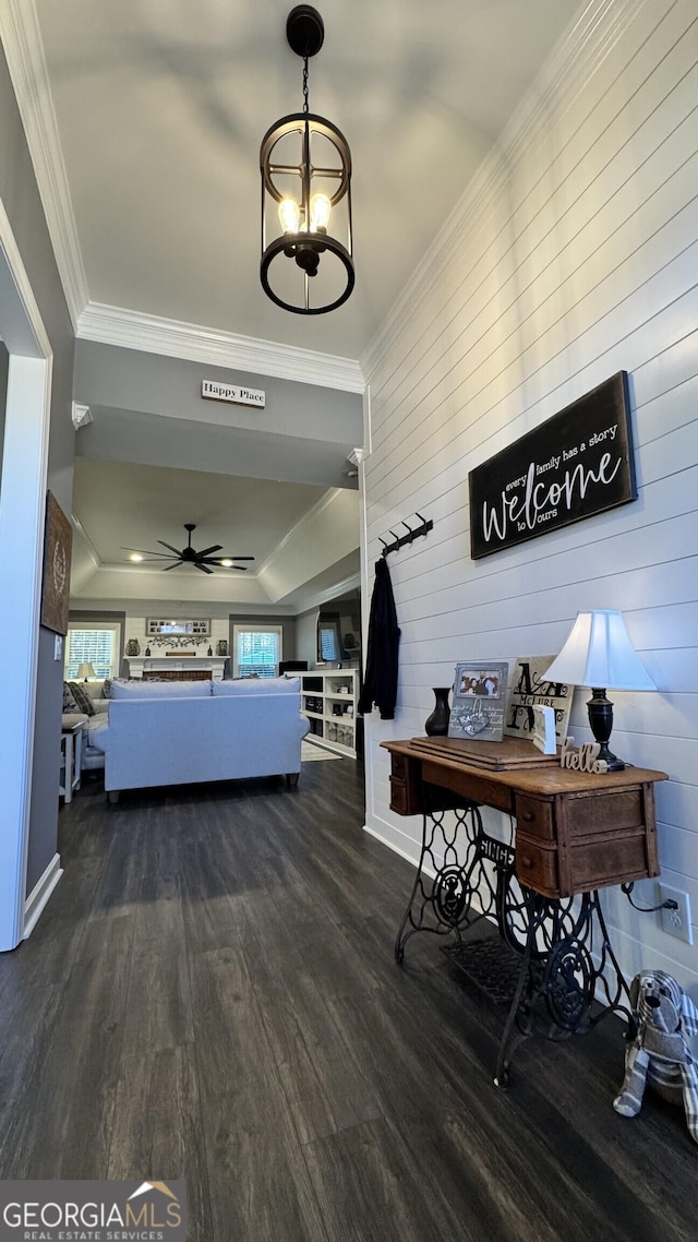 unfurnished bedroom with wood walls, dark hardwood / wood-style flooring, crown molding, and a chandelier