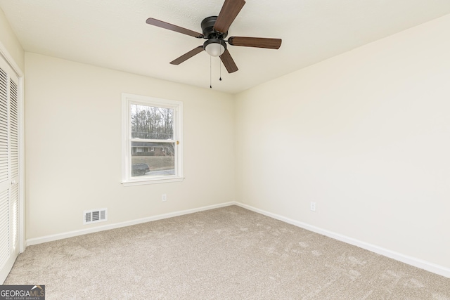 unfurnished bedroom featuring a closet, ceiling fan, and light colored carpet