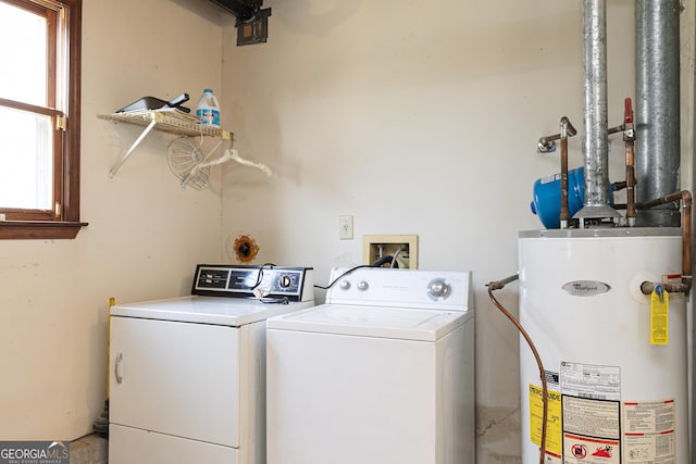 washroom with water heater and independent washer and dryer