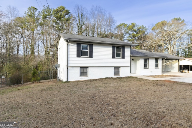 tri-level home with a front yard and a carport