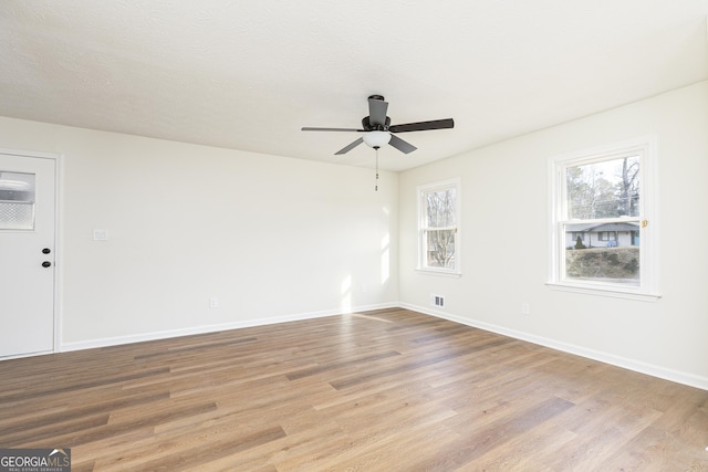 spare room with ceiling fan and light hardwood / wood-style floors