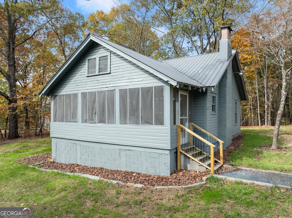 view of front of property with a sunroom