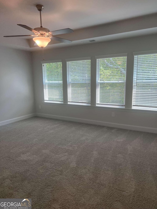 unfurnished room featuring carpet floors, plenty of natural light, and ceiling fan