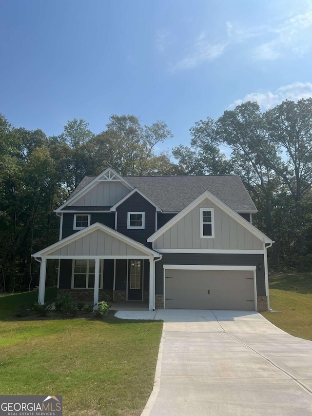 craftsman-style house featuring covered porch, a garage, and a front lawn