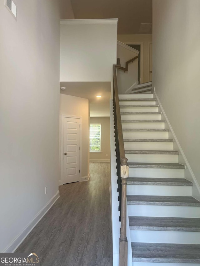 staircase with hardwood / wood-style flooring