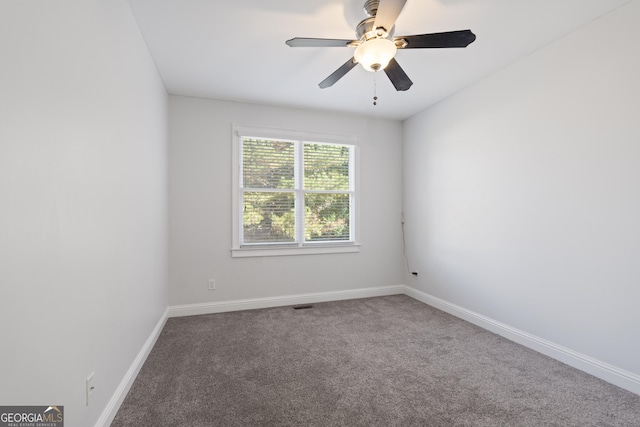 unfurnished room featuring ceiling fan and carpet floors