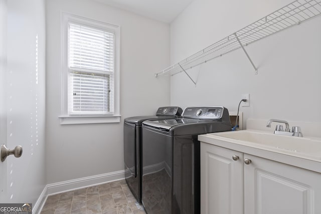 washroom featuring washer and clothes dryer, cabinets, and sink