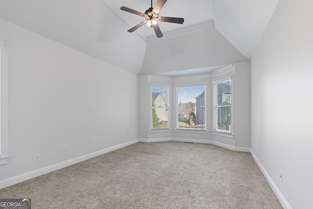 carpeted spare room with crown molding, ceiling fan, and lofted ceiling