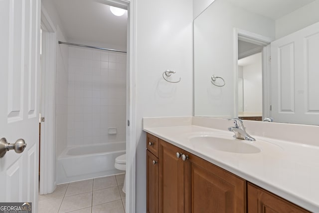 full bathroom featuring tile patterned flooring, vanity, toilet, and tiled shower / bath