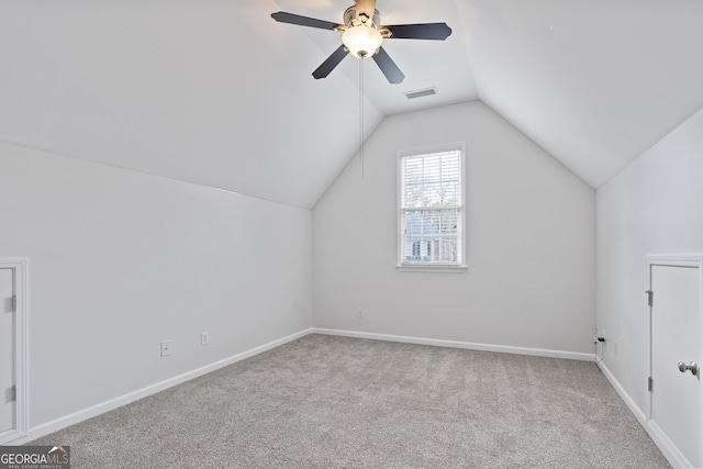 additional living space featuring light carpet, ceiling fan, and vaulted ceiling