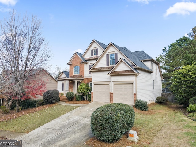 view of front of property with a garage and a front lawn