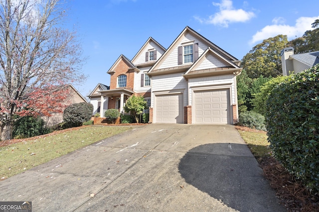 craftsman inspired home with a garage and a front lawn