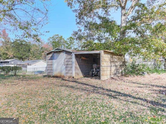 view of outbuilding with a lawn