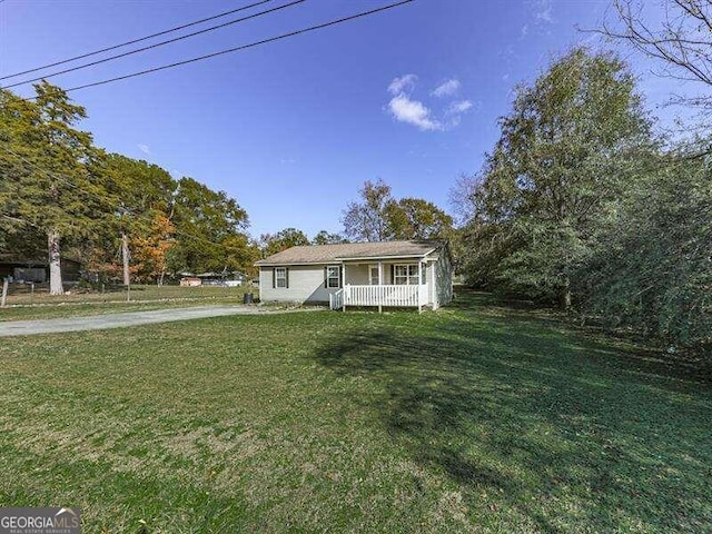 view of front of property with covered porch and a front yard