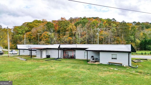 back of property featuring a lawn