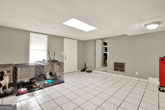 basement with heating unit and light tile patterned floors