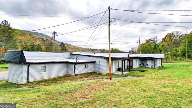 back of house with a lawn