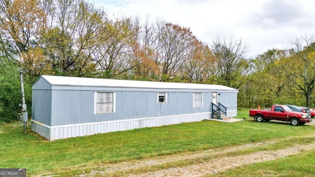 view of outbuilding with a yard